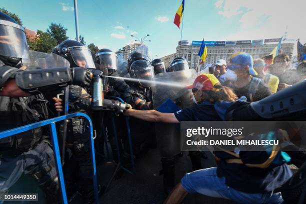 Romanian police scuffle with protesters and spray tear gas against them during an anti-government protest in front of the Romanian Government...