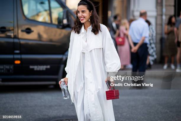 Bettina Looney wearing white dress , red mini bag is seen outside Baum und Pferdgarten during the Copenhagen Fashion Week Spring/Summer 2019 on...