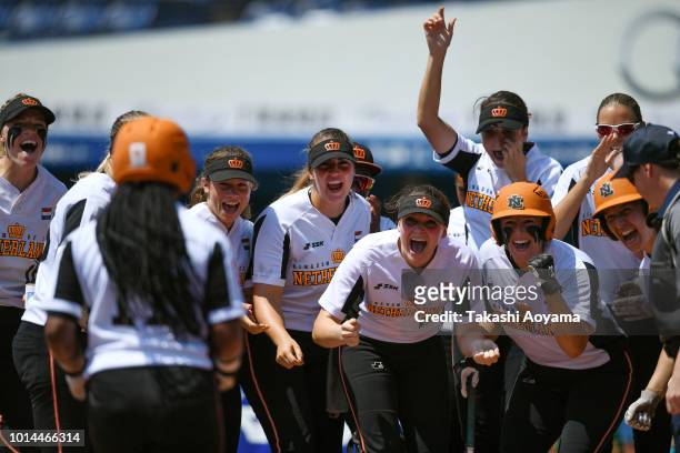 Soclaina Naphtalini Van Gurp of Netherlands celebrates as she rounds the bases after hitting solo home run in the second inning against Canada during...