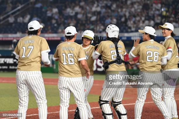 Yu Yamamoto of Japan celebrates after hitting a grand slam in the second inning against Puerto Rico during their Playoff Round at ZOZO Marine Stadium...