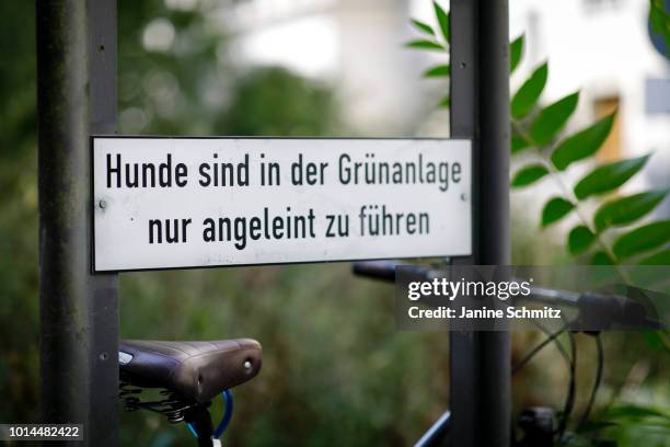 Sign in an urban green area indicates that dogs should be leashed on August 08, 2018 in Berlin, Germany.