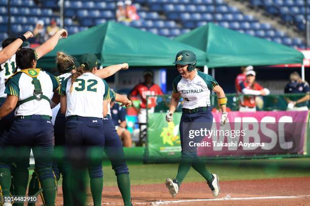 Stacey Anne Porter of Australia celebrates with team mates after hitting a solo home run in the fourth inning against United States during their...