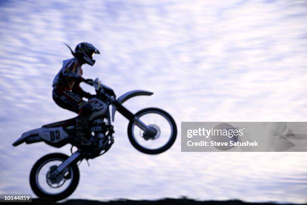 motocross race motion effect - motorcycle stunt stock pictures, royalty-free photos & images