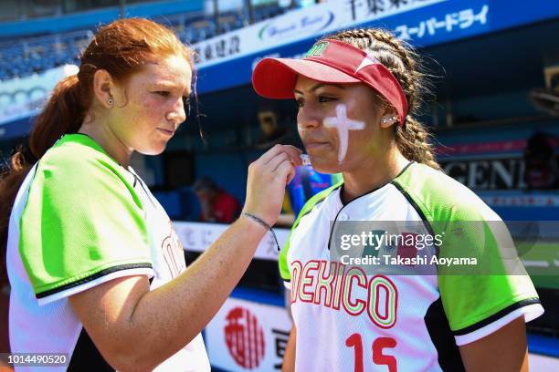 Suzannah Lillian Brookshire Gonzalez paints big cross on Eliyah Elizabeth Flores Sanchez prior to the Playoff Round match between Mexico and Italy at...