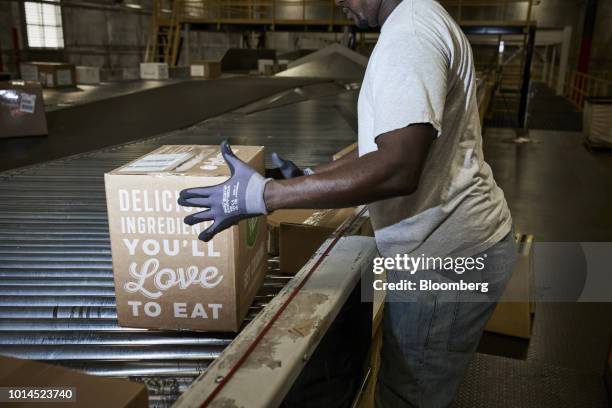 An employee sorts packages for delivery at the FedEx Corp. Ground distribution center in Jersey City, New Jersey, U.S., on Tuesday, Aug. 7, 2018....