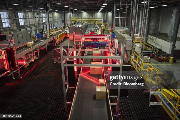 Packages move through an automated scanner at the FedEx Corp. Ground distribution center in Jersey City, New Jersey, U.S., on Tuesday, Aug. 7, 2018....