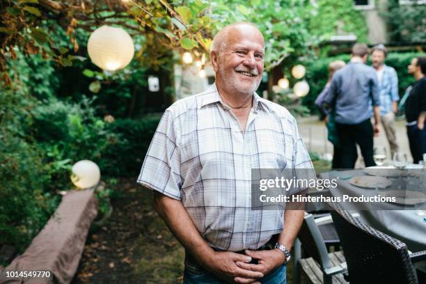 portrait of elderly man during family meal - bald people stock pictures, royalty-free photos & images