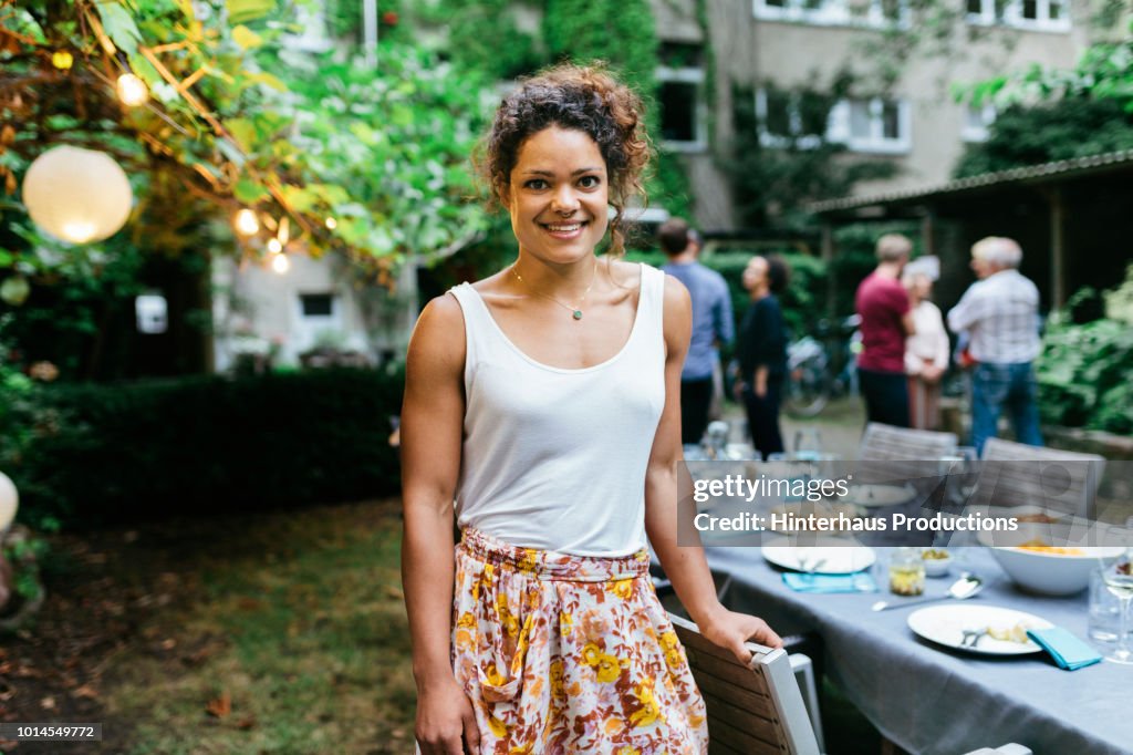 Portrait Of A Young Woman Smiling At Family BBQ