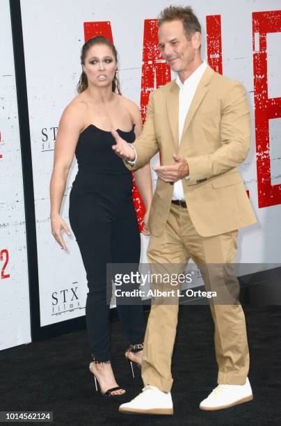 Actress Ronda Rousey and director Peter Berg arrive for the Premiere Of STX Films' "Mile 22" held at Westwood Village Theatre on August 9, 2018 in...