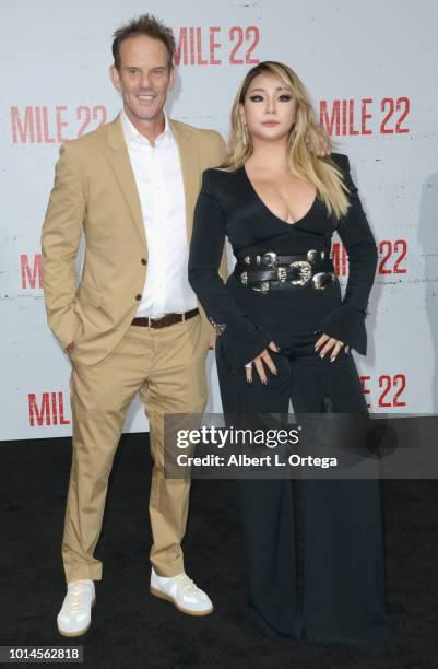 Director Peter Berg and CL arrive for the Premiere Of STX Films' "Mile 22" held at Westwood Village Theatre on August 9, 2018 in Westwood, California.