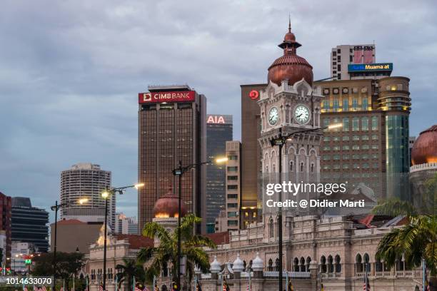 the historic sultan abdul samad building contrast with the financial district towers by merdeka square in the heart of kuala lumpur, malaysia capital city - malaysia kuala lumpur merdeka square stock pictures, royalty-free photos & images