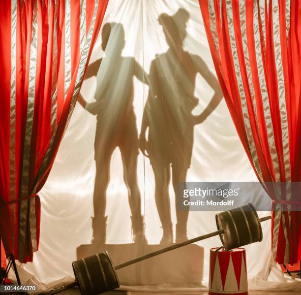 shadows of children circus performers on curtain - young kid and barbell stock pictures, royalty-free photos & images