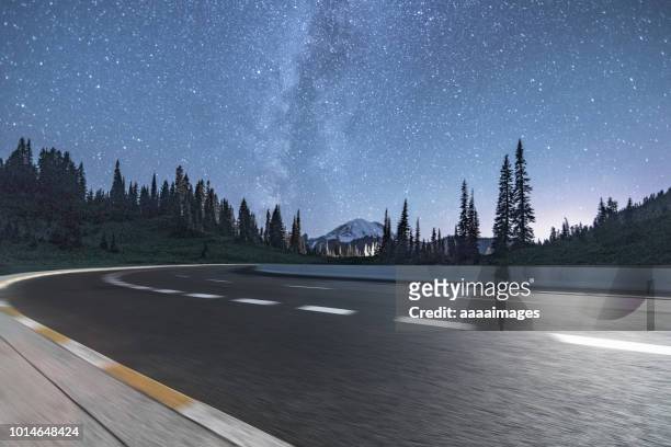 road trip under the milkyway - mountain road stock pictures, royalty-free photos & images