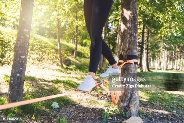 slacklining - woman tightrope stock pictures, royalty-free photos & images