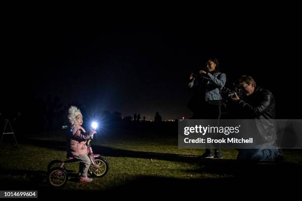 Young girl poses for a photo during the Valley Of Light Public Art Experience at Centennial Park on August 10, 2018 in Sydney, Australia. Hundreds...