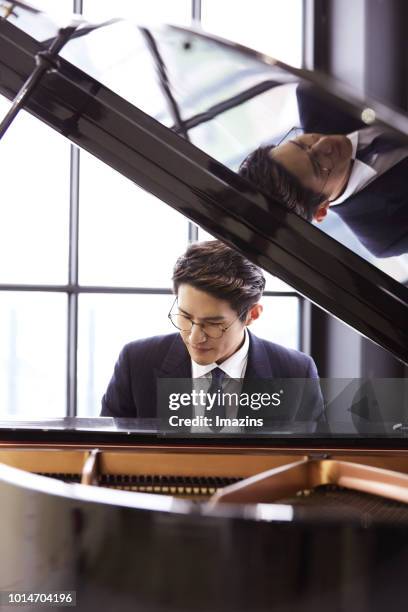 businessman playing piano - pianist front stock pictures, royalty-free photos & images