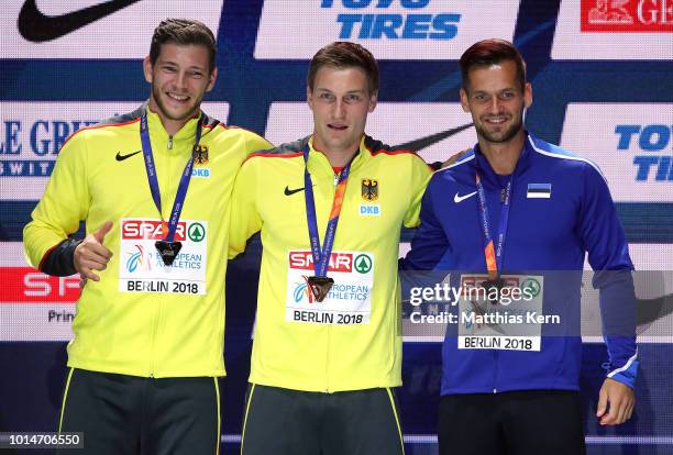 Andreas Hofmann of Germany, silver, Thomas Roehler of Germany, gold, and Magnus Kirt of Estonia, bronze, pose with their medals for the Men's Javelin...