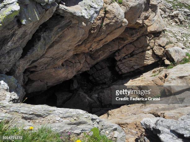 entrance to the cave "pozzo del matörgn" near robiei - cave entrance stock pictures, royalty-free photos & images