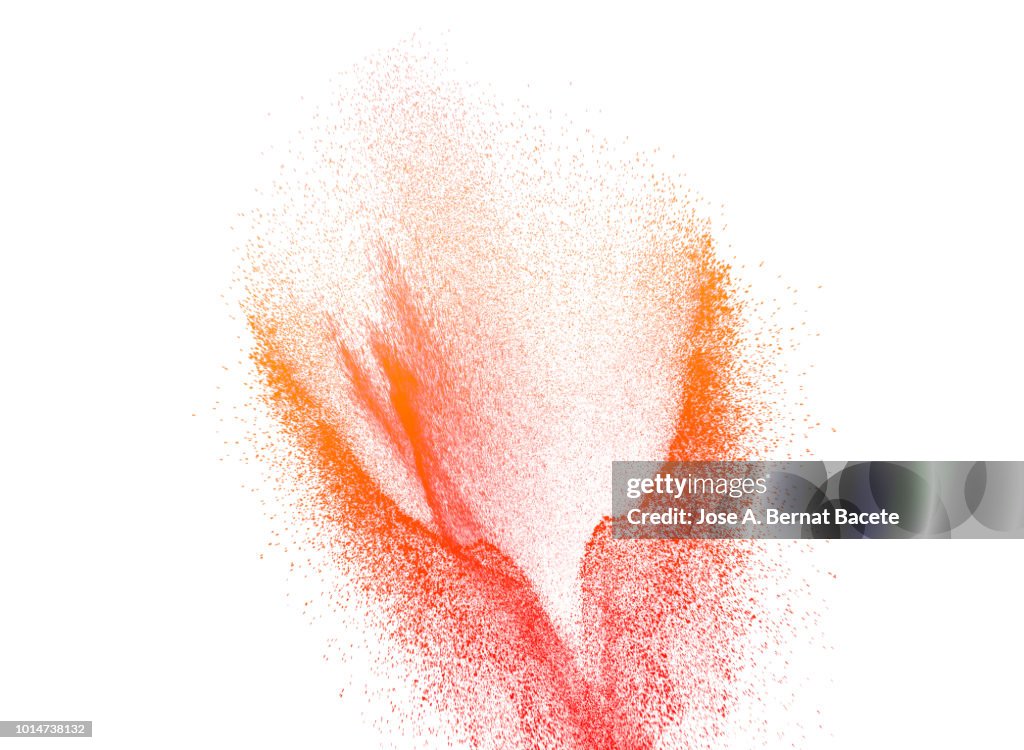 Explosion by an impact of a cloud of particles of powder of color orange and red on a white background.