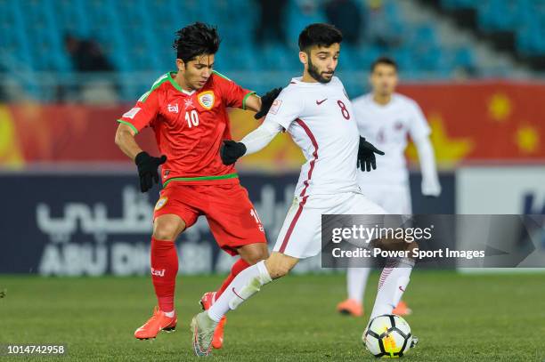 Ahmad Moein of Qatar fights for the ball with Azan Al Tamtami of Oman during the AFC U23 Championship China 2018 Group A match between Oman and Qatar...