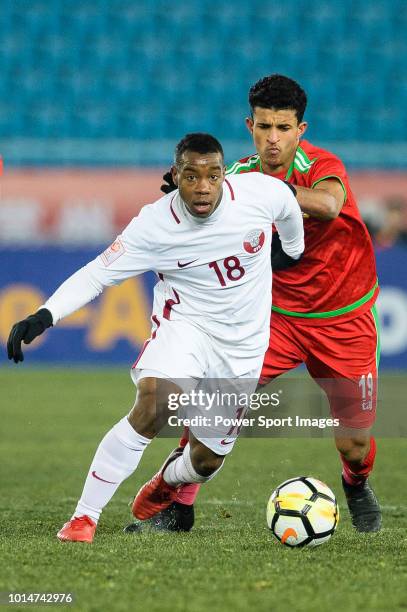 Assim Madibo of Qatar fights for the ball with Zahir Al Aghbari of Oman during the AFC U23 Championship China 2018 Group A match between Oman and...