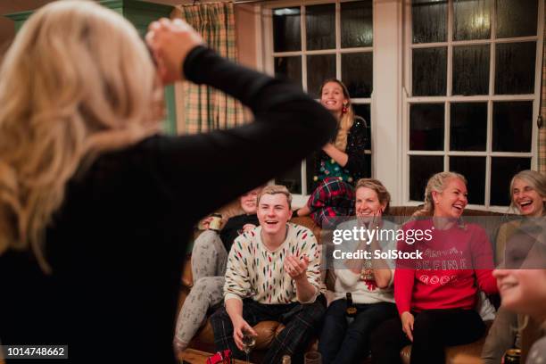 playing a modern guessing game at christmas - pantomime stock pictures, royalty-free photos & images