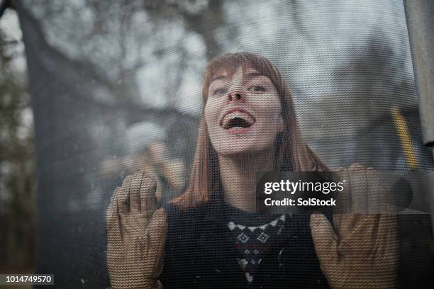 making a face on the trampoline - netting stock pictures, royalty-free photos & images