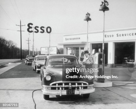 ATTENDANT AT ESSO SERVING CUSTOMER, CIRCA 1949