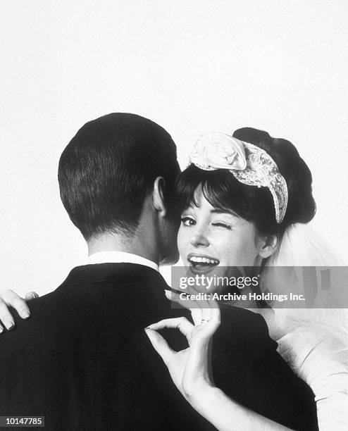 bride hugging husband, okay gesture, 1963 - bride and groom looking at camera stock-fotos und bilder