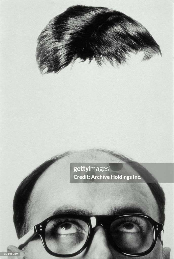 MANS TOUPEE HOVERING OVERHEAD, 1965