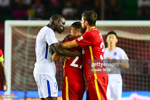 Demba Ba of Shanghai Shenhua argues with Zhang Li of Changchun Yatai during the 2018 Chinese Super League match between Changchun Yatai and Shanghai...