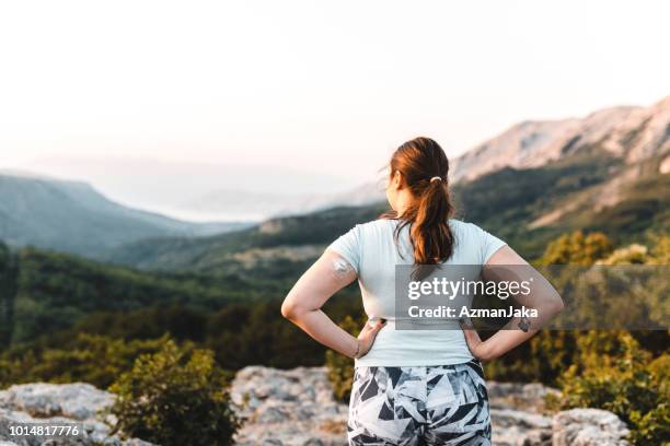 woman with diabetes wearing a continuous glucose monitoring system and admiring the view - continuous glucose monitor stock pictures, royalty-free photos & images