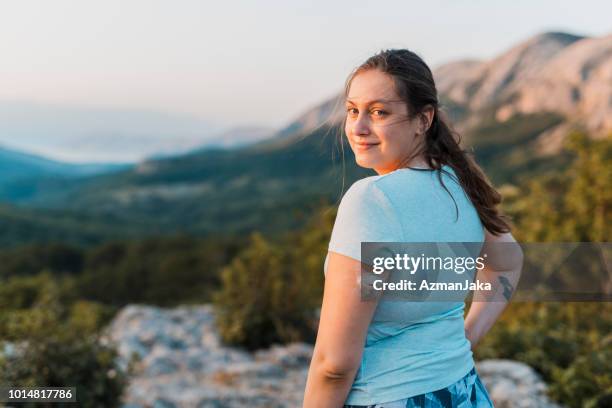 woman with diabetes standing on top of the hill and looking at camera - diabetes care stock pictures, royalty-free photos & images