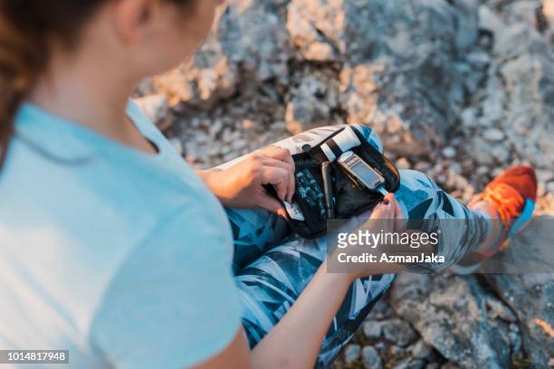 woman with diabetes checking her blood glucose using her glucose meter - checking sports stock pictures, royalty-free photos & images