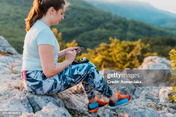 frau mit diabetes kontrollieren ihren blutzucker mit ihrem blutzuckermessgerät - blutzuckerspiegel stock-fotos und bilder