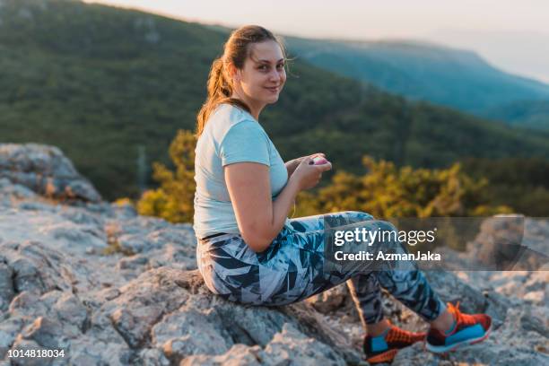 woman with diabetes using her insulin pump - insulin pump stock pictures, royalty-free photos & images