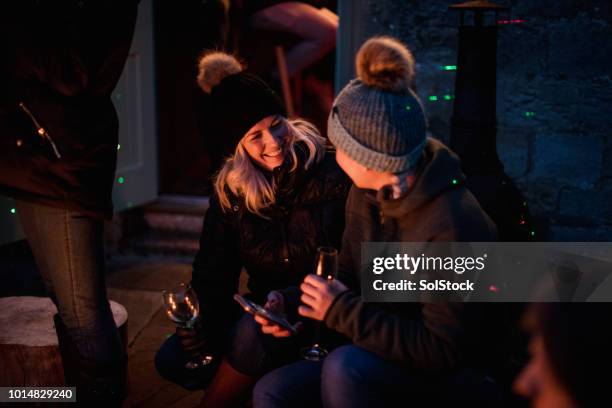 women talking by the campfire - bonfire stock pictures, royalty-free photos & images