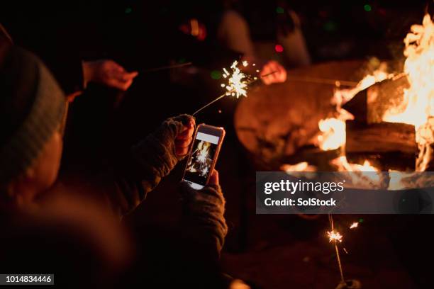 taking a photo of sparklers - bonfire stock pictures, royalty-free photos & images