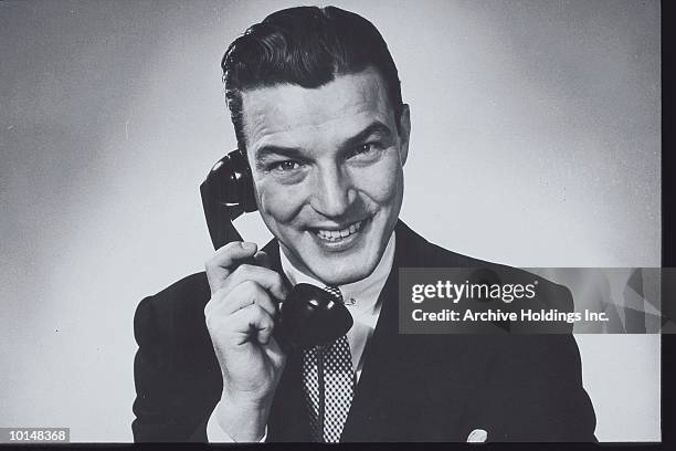 businessman on the phone, circa 1950s - telefono fijo fotografías e imágenes de stock