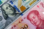 Face to face of US dollar banknote and China Yuan banknote for 2 biggest economic in the world which now United states of America and China have war trade.