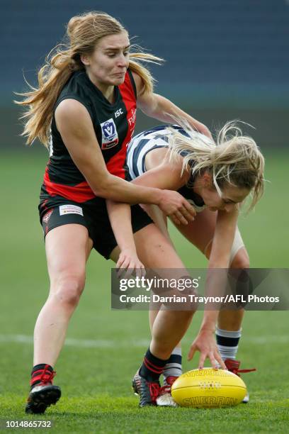 Alexa Madden of Essendon tackles Amy McDonald of Geelong during the round 14 VFLW match between the Essendon Bombers and the Geelong Cats at GMHBA...