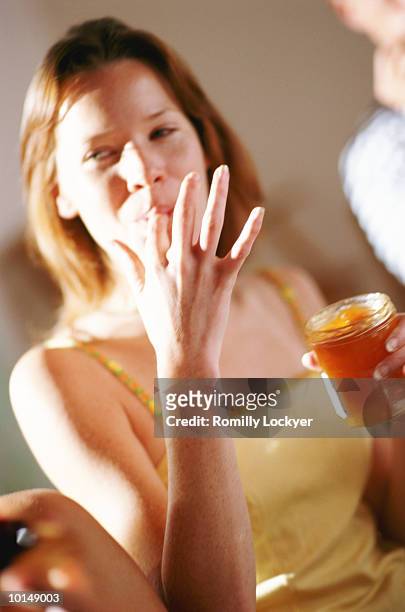 young woman having breakfast - 指をくわえる ストックフォトと画像