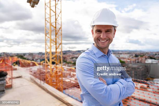 happy architect at a construction site - helm stock pictures, royalty-free photos & images