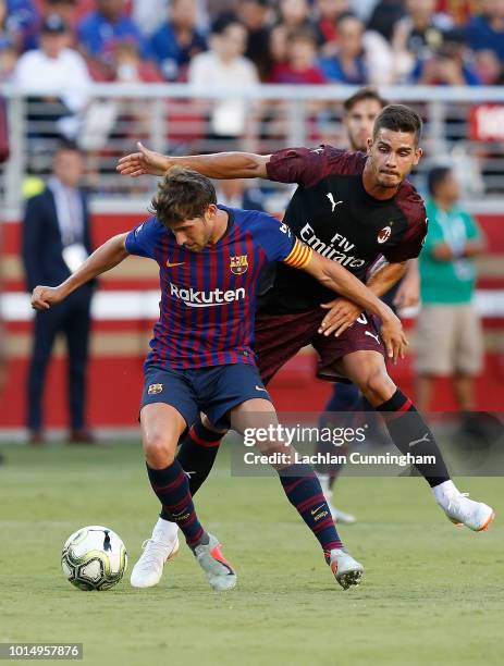 Andre Silva of AC Milan competes for the ball against Sergi Roberto of FC Barcelona during the International Champions Cup match at Levi's Stadium on...