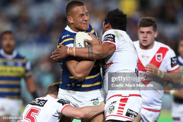 Kane Evans of the Eels is tackled during the round 22 NRL match between the Parramatta Eels and the St George Illawarra Dragons at ANZ Stadium on...