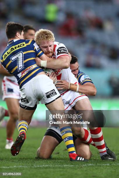 James Graham of the Dragons is tackled during the round 22 NRL match between the Parramatta Eels and the St George Illawarra Dragons at ANZ Stadium...