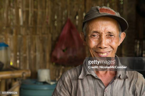 senior indonesian farmer smiling portrait in hut - indonesia stock pictures, royalty-free photos & images