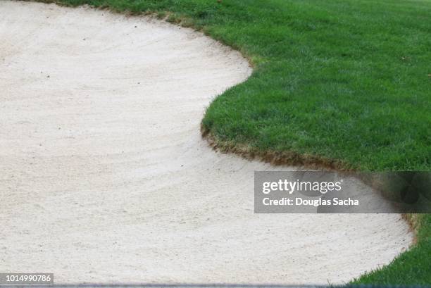 full frame of a sand bunker at a golf course - golf bunker stock-fotos und bilder