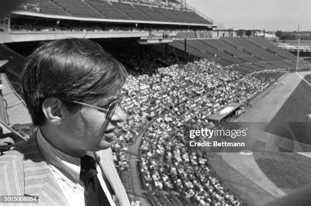 Allen "Bud" Selig, President of the Milwaukee Brewers surveyed part of the 24,817 fans attending the Brewers-Boston Red Sox game bringing the Brewers...