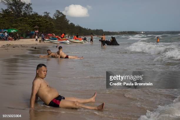 Chinese tourists enjoy a sunny afternoon on the beach August 3, 2018 in Sihanoukville, Cambodia. Chinese money accounted for about 30 percent of...